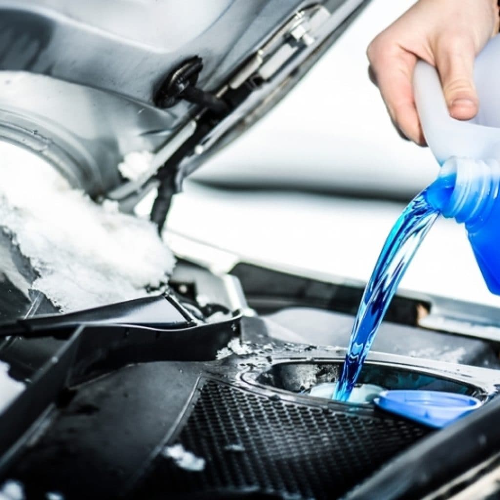 Filling up car fluids in the snow
